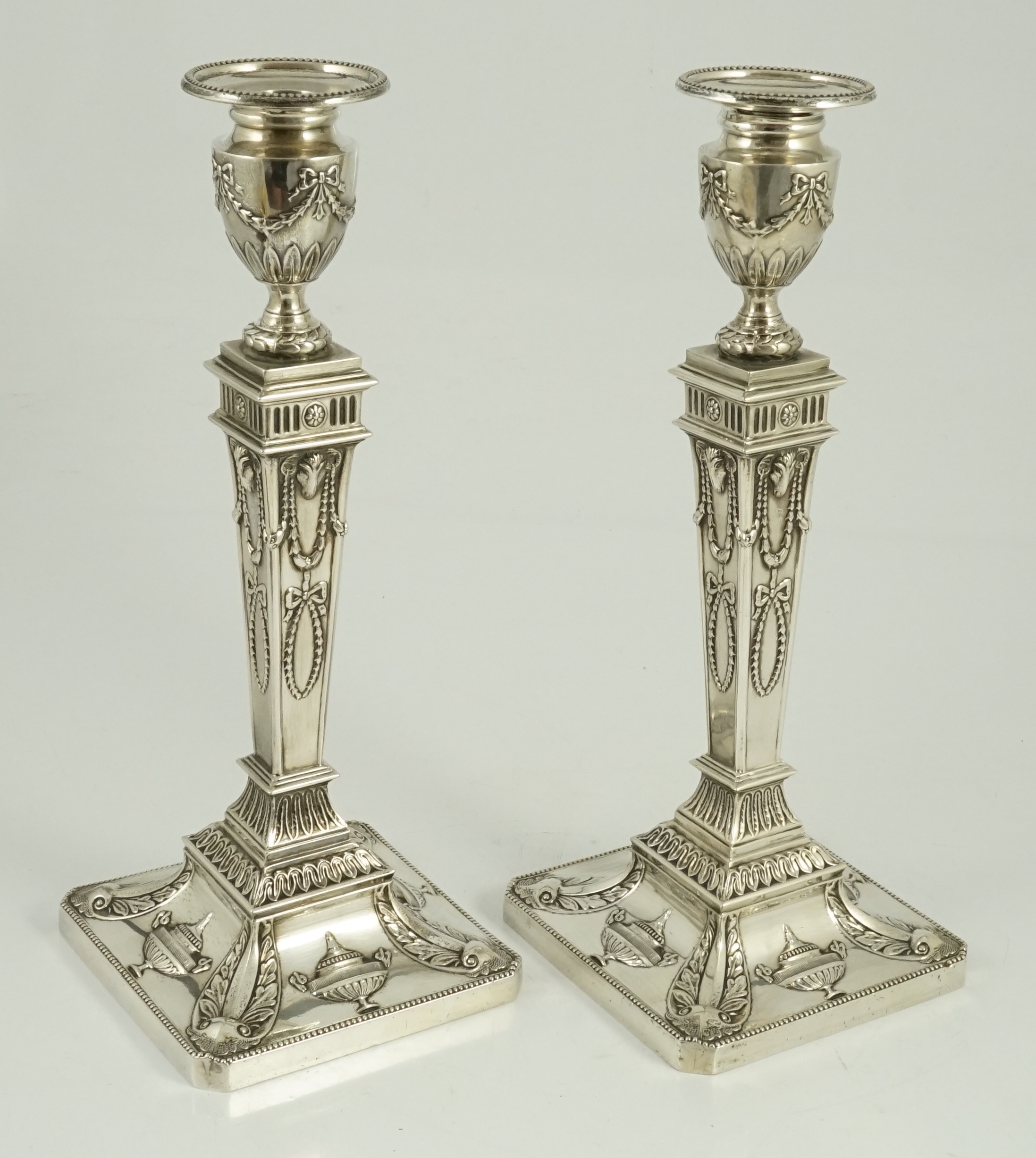 A pair of Elizabeth II Adam style silver candlesticks, by Barker Ellis Silver Co